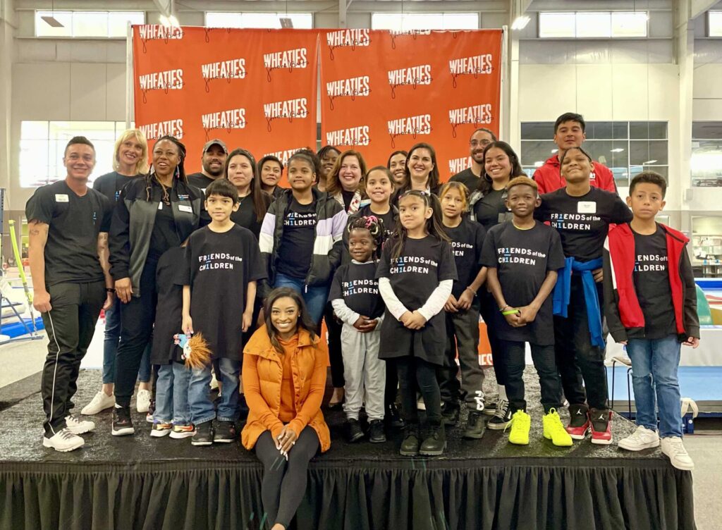 Gymnast Simone Biles with Nancy Pollard and Friends of the Children Austin youth and staff, at Friends Houston launch