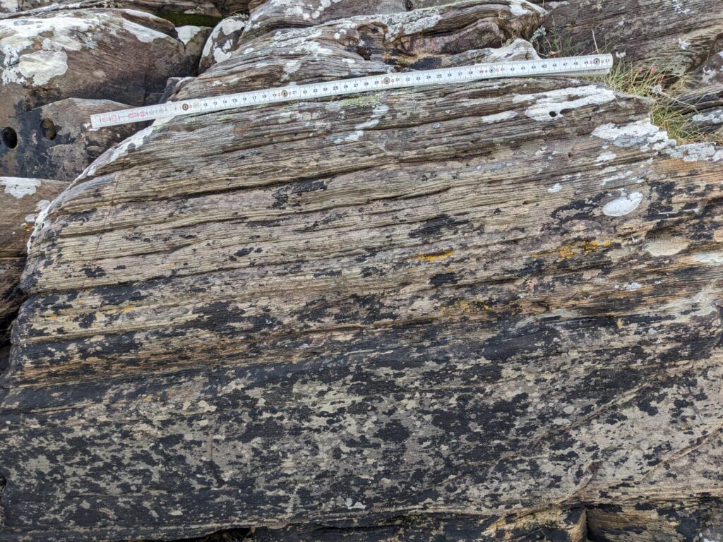 Millimetre-scale layers called varves record year-to-year deposition and climate cycles during Snowball Earth. These rocks are exposed on the uninhabited island of Garbh Eileach. Photo courtesy of Tom Gernon.